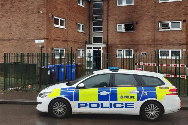 Police officers remain at the scene of the blaze, while a crime scene investigation team examines the block of flats.