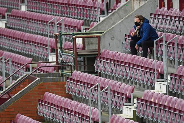 Hearts manager Robbie Neilson sits in the stand at Tynecastle Park.