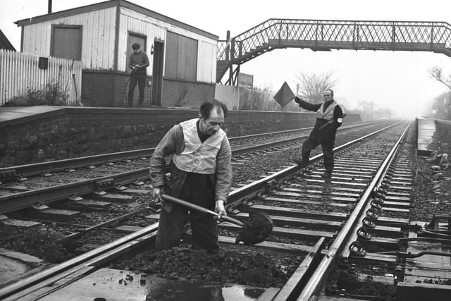 A workman in a safety vest works on the line at Kingsknowe railway station in Edinburgh before it reopened in January 1970.