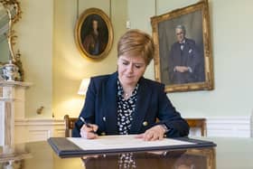 Nicola Sturgeon signs her official letter of resignation as First Minister to King Charles III (Picture: Jane Barlow/PA)