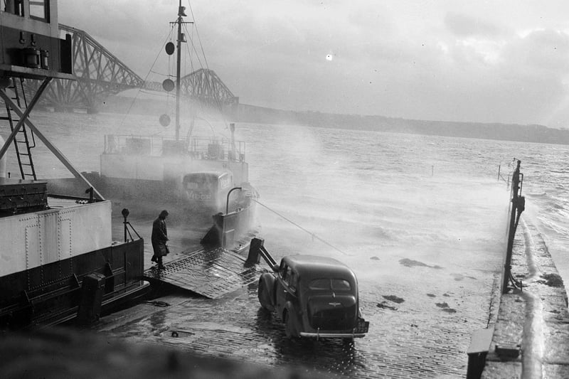 Stormy weather at North Queensferry. A car boards the ferry for the crossing of the Forth to South Queensferry.  January 1953.