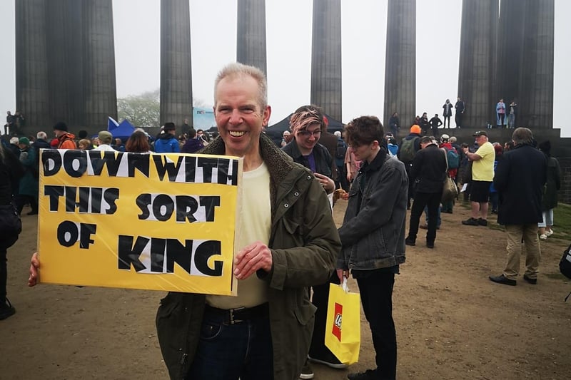 One protester has a sign which reads: "Down with this sort of king".