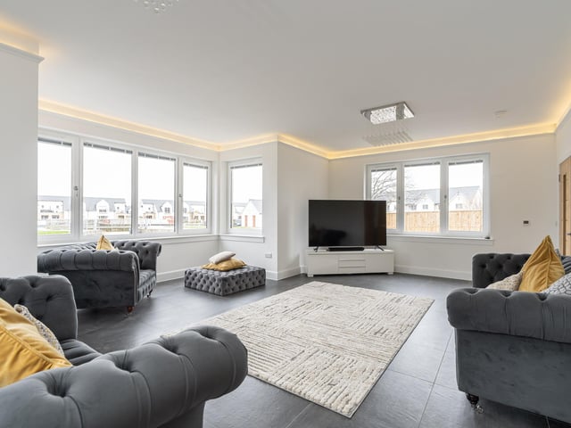 The generously proportioned bay fronted living room which enjoys a dual facing aspect and features ambient ceiling lighting and high spec flooring