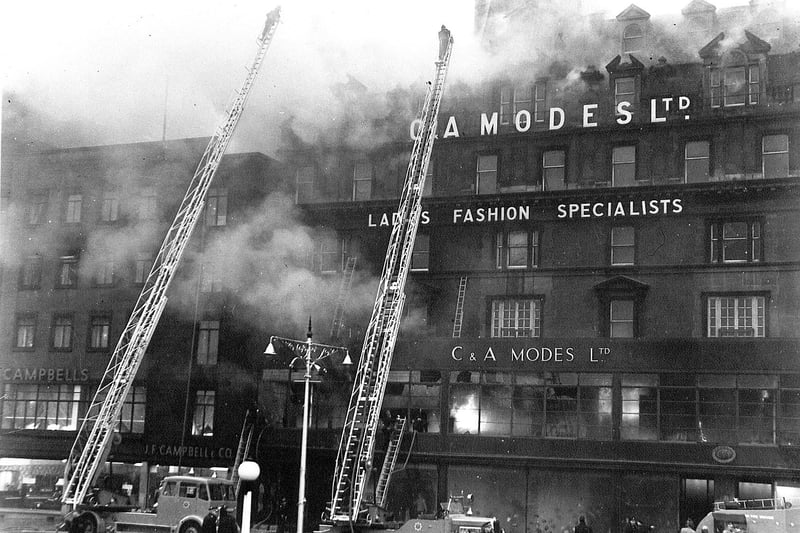Fireman on turntable ladders battle the blaze at C&A department store on Princes Street, Edinburgh on November 9 1955. The Victorian building was demolished and replaced by a new build.