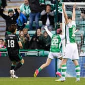 Celtic's Scott Bain looks dejected after conceding the third goal as the Hibs players celebrate