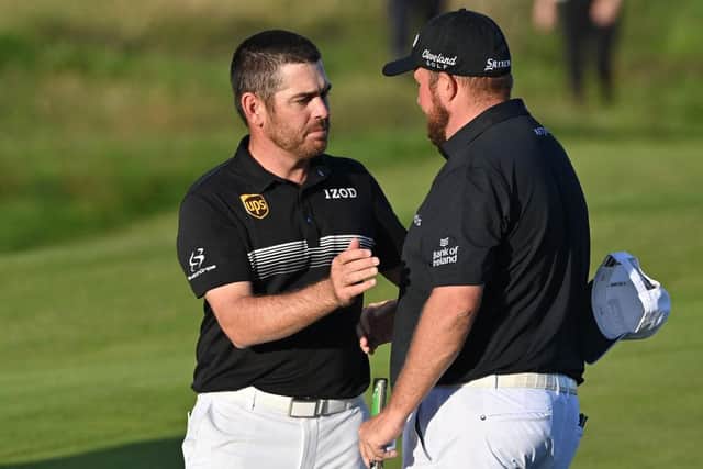 Halfway leader Louis Oosthuizen shakes hands with defending champion Shane Lowry after the second round in the 149th Open. Picture: Paul Ellis/AFP via Getty Images.