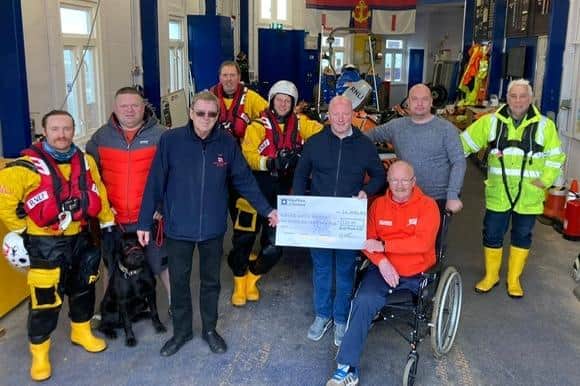 Scottish international Barry McEwan and James Ogilvie handing over a cheque from the Bass Rock Shore Angling League to Ian McMinn, deputy launching authority, at the Royal National Lifeboat Institution at North Berwick. Contributed by Bass Rock