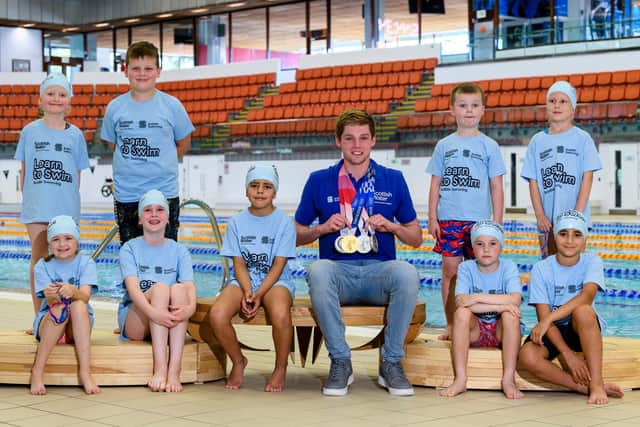 Olympic star Duncan inspires youngsters with a visit to Edinburgh's 'Commie Pool' - along with his medals haul.