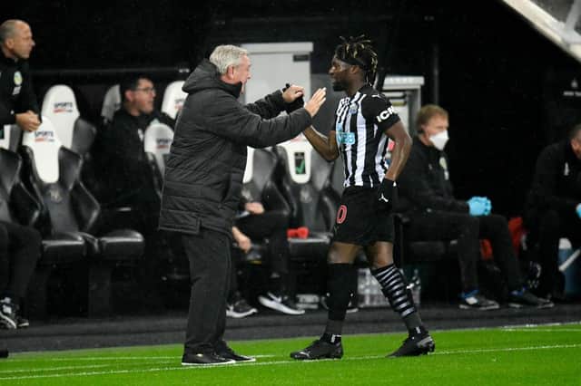 Allan Saint-Maximin of Newcastle United celebrates with Steve Bruce, Manager of Newcastle United after scoring his team's first goal during the Premier League match between Newcastle United and Burnley at St. James Park on October 03, 2020 in Newcastle upon Tyne, England.