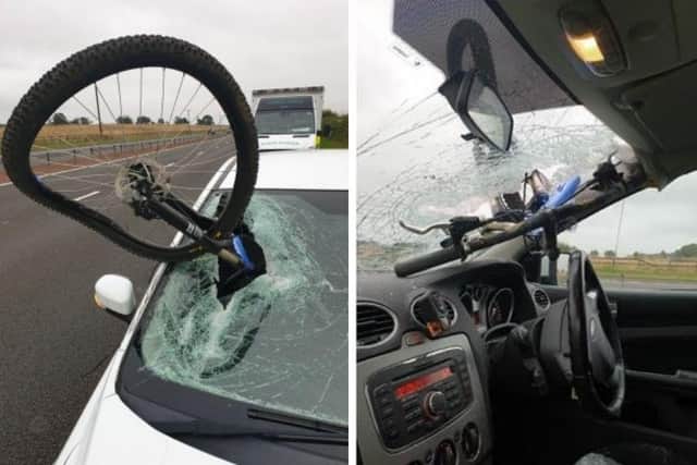 Police Scotland is appealing for information after a bicycle crashed into a moving car on the M9 after coming free from another vehicle.