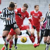 Aberdeen's Florian Kamberi (centre) is challenged by Ethan Erhahon (L) and Jak Doyle-Hayes of St Mirren during Saturday's 0-0 draw with St Mirren  (Photo by Ross MacDonald / SNS Group)