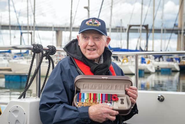Royal Navy World War Two gunner Harry Hogg, 102, proudly wore his medals when he came aboard.