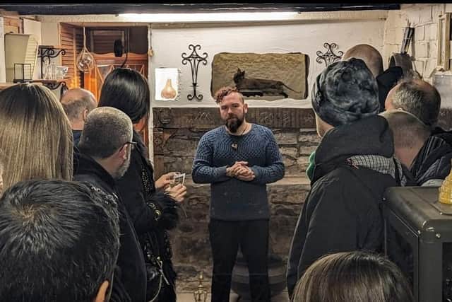 Museum of Magic, Fortune-telling & Witchcraft curator Ash William Mills welcoming visitors to the new tourist attraction just off the High Street at the opening night last Saturday.