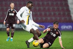 Hearts midfielder Cammy Devlin challenges Joel Nouble during the Scottish Cup tie with Livingston at Tynecastle. Picture: SNS
