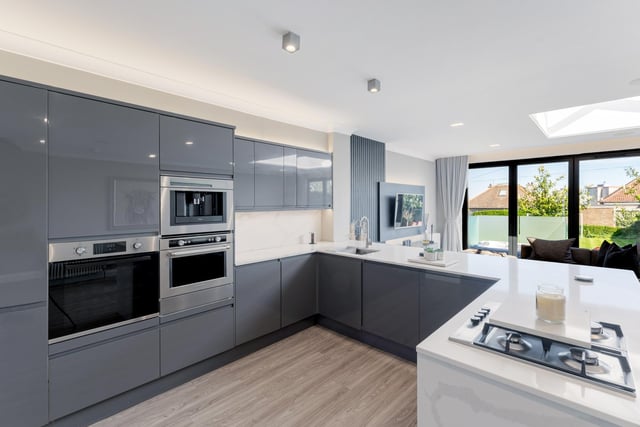 The modern kitchen/dining area is fitted with an abundance of high-quality base and wall mounted units affording exceptional storage spaces and is complimented with integrated appliances.
