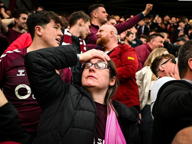 Hearts fans react after the final whistle (Photo by ANDY BUCHANAN / AFP via Getty Images)