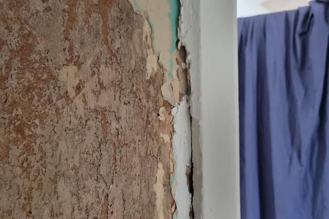 Plaster coming off of the walls and has been described as a 'decorative' repair by the council.