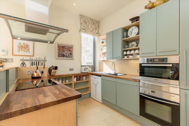 The kitchen is fitted with a range of wall mounted and floor standing units, ample space for a dining table and chairs and patio doors opening onto a second south-facing balcony.