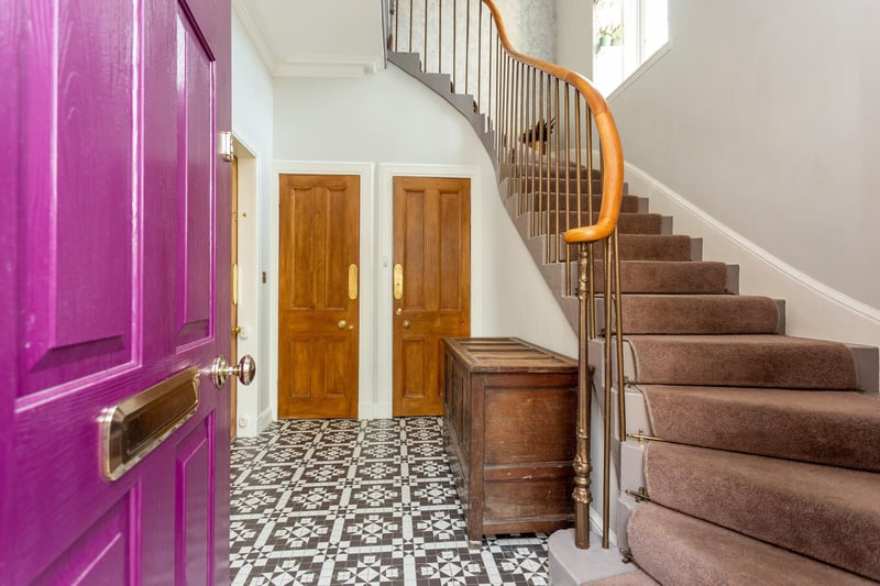 The property's reception hall, providing an excellent introduction to the property with stone stairs, wrought iron spindles and polished handrail, feature tiled floor and stripped doors.