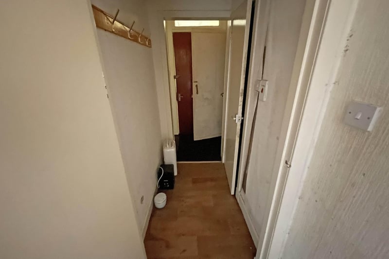 A hallway opens to each of the rooms in this Dalry flat.