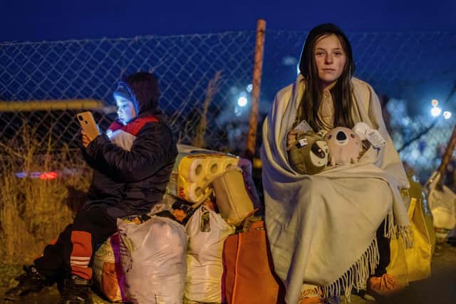 Helena and her younger brother Bodia from Lviv, Ukraine, are seen at the Medyka border crossing in eastern Poland (Picture: Wojtek Radwanski/AFP via Getty Images)