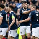 John McGinn is congratulated by his team-mates after opening the scoring at Hampden Park. Picture: SNS