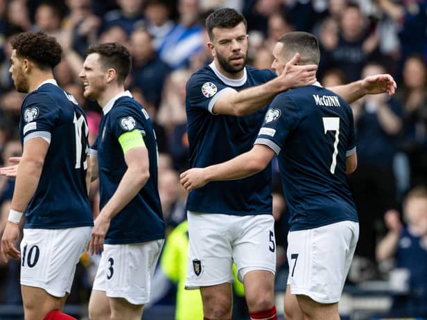 John McGinn is congratulated by his team-mates after opening the scoring at Hampden Park. Picture: SNS