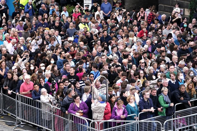 Members of the public during an Accession Proclamation Ceremony at Mercat Cross, Edinburgh, publicly proclaiming King Charles III as the new monarch. Picture date: Sunday September 11, 2022.
