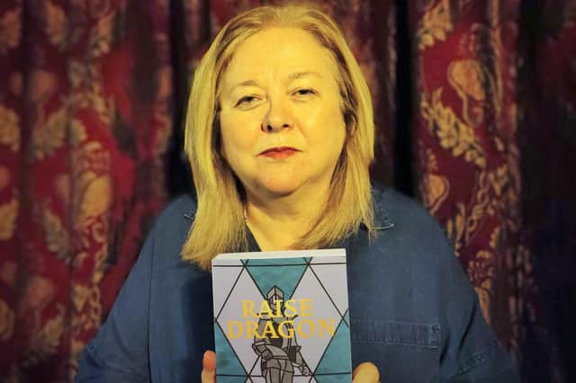 Lynda Kristiansen from Eskbank, with a copy of her debut novel 'Raise Dragon'.