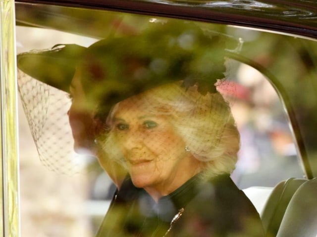 Camilla, the Queen Consort, sits in a car heading towards Westminster Abbey