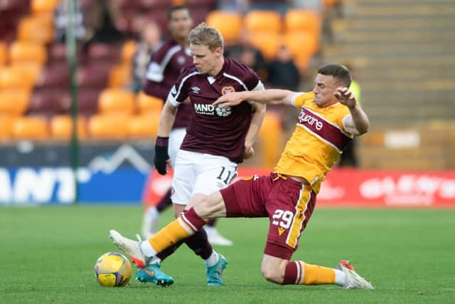 Connor Shields tackles Hearts winger Gary Mackay-Steven during the cinch Premiership match at Motherwell's Fir Park. Picture: SNS