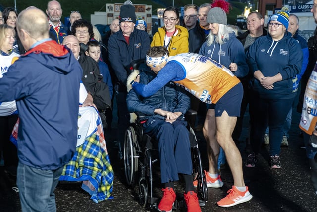 Kevin Sinfield embraces pal Doddie Weir on day one of the Ultra 7 in 7 Challenge from Murrayfield to Melrose.