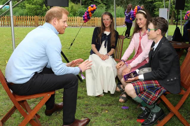 Prince Harry with William Cuthill and his family.