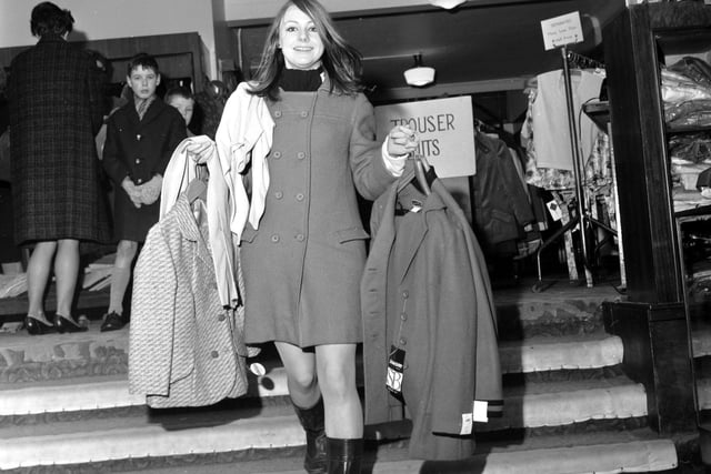 Shopper Caroline Kenley makes the most of the winter sale at Small's in Princes Street in 1967.