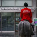 A mounted fox hunter rides through the Capital to highlight the fact that the cruel pastime of fox hunting is still happening