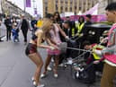 Cast and crew from The Ladyboys of Bangkok have been clearing rubbish up outside their venue on Lothian Road. Picture: Duncan McGlynn