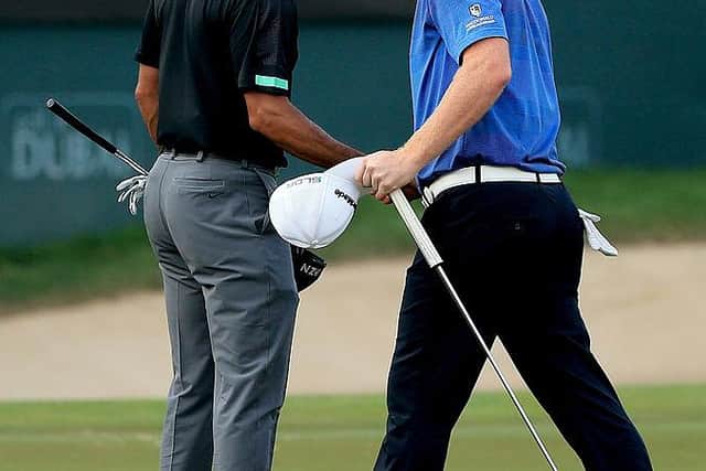 Tiger Woods and Stephen Gallacher shake hands during the 2014 Omega Dubai Desert Classic. PIcture: Francois Nel/Getty Images.
