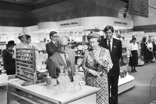Queen Elizabeth II chats to Fred Lonie at the Edinburgh Crystal department when she visits the 150th anniversary exhibition at Jenners department store in June 1988.