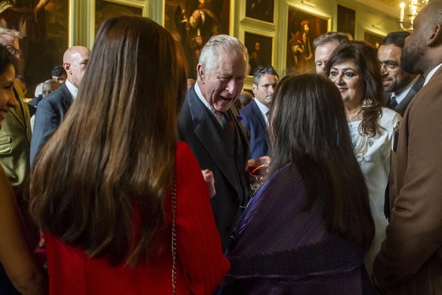 As Charles and Camilla spoke to people in the hall, they were encircled by well-wishers wanting to shake hands and take pictures.