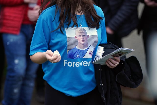 A mourner wearing a t-shirt with a picture of Andrew MacKinnon at the packed service on Friday
Andrew Milligan/PA Wire