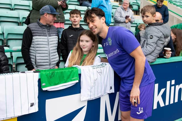 Joe Newell meets a young fan during an open training session at Easter Road in May