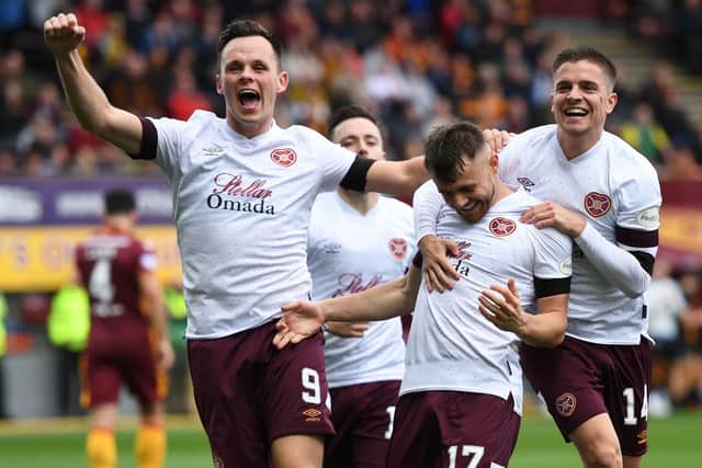 Lawrence Shankland, Alan Forrest and Alan Forrest celebrate after Hearts go two up at Fir Park.  Picture: Ross MacDonald / SNS