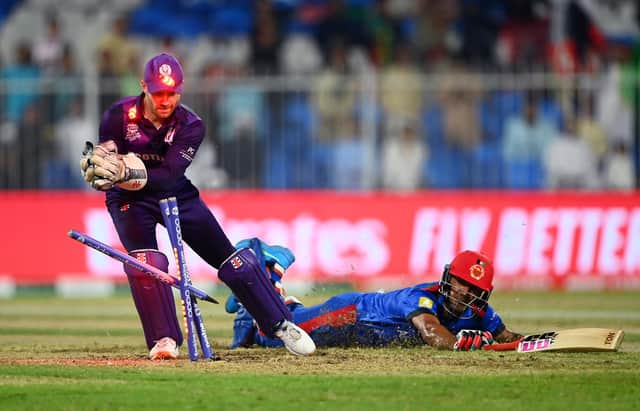 Najibullah Zadran of Afghanistan dives for the crease as Matthew Cross of Scotland removes the bails during a T20 World Cup match between Afghanistan and Scotland (Picture: Alex Davidson/Getty Images)