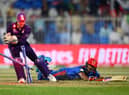 Najibullah Zadran of Afghanistan dives for the crease as Matthew Cross of Scotland removes the bails during a T20 World Cup match between Afghanistan and Scotland (Picture: Alex Davidson/Getty Images)