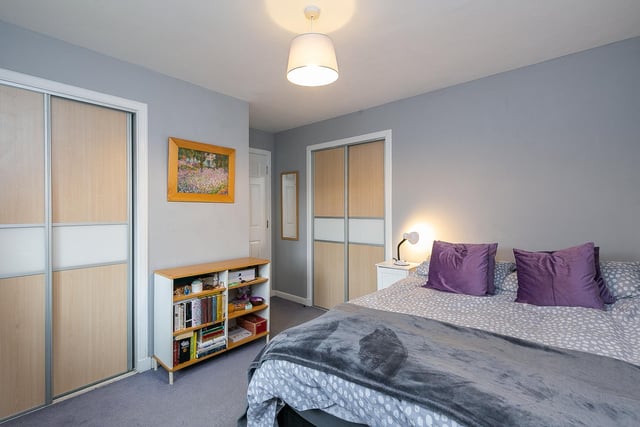 Bedroom two is also set to the rear and features carpeted flooring, two built-in wardrobes, a central light fitting and another modern en-suite shower room.