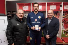 Craig Gordon received his 50th cap medal from Willie Miller and SFA chairman Alan McRae at Pittodrie in 2017. Picture: SNS