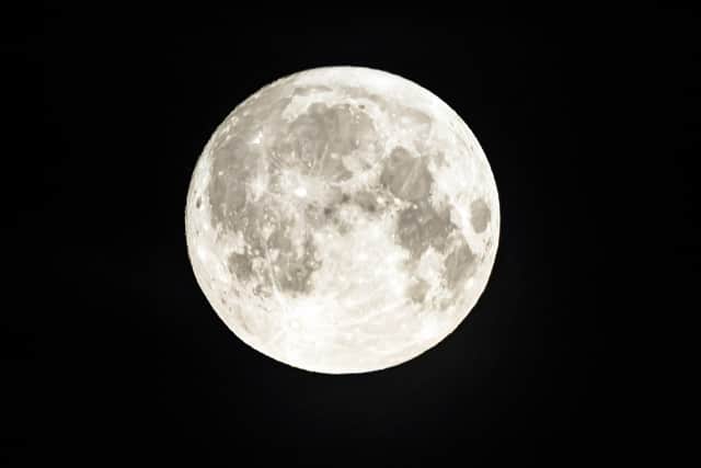 Here's how you can see the supermoon in Edinburgh tonight. The strawberry supermoon sets behind above Huddersfield in Yorkshire. Picture date: Tuesday June 14, 2022.