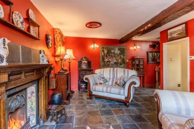 An open fire in cast iron surround coupled with the vibrant decor of the room create a warm environment in the lounge which has a slate tiled floor, oak windowsills and stone mullions.