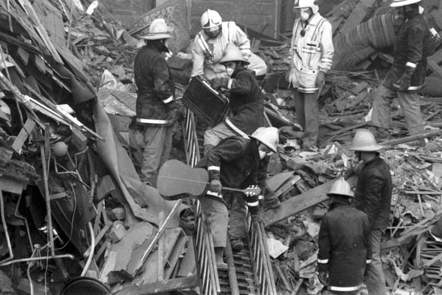 Rescue workers from the Fire Service, brought in to look for survivors of the Guthrie Street gas explosion, which killed two people and destroyed two tenements in Edinburgh's Old Town in October 1989. Firemen pull personal belongings from the debris.