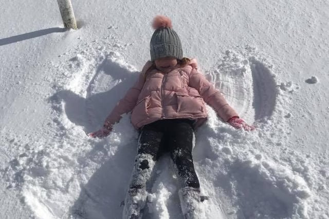 One Edinburgh schoolgirl created snow angels after the Beast from the East left a heavy layer of snow on the ground.